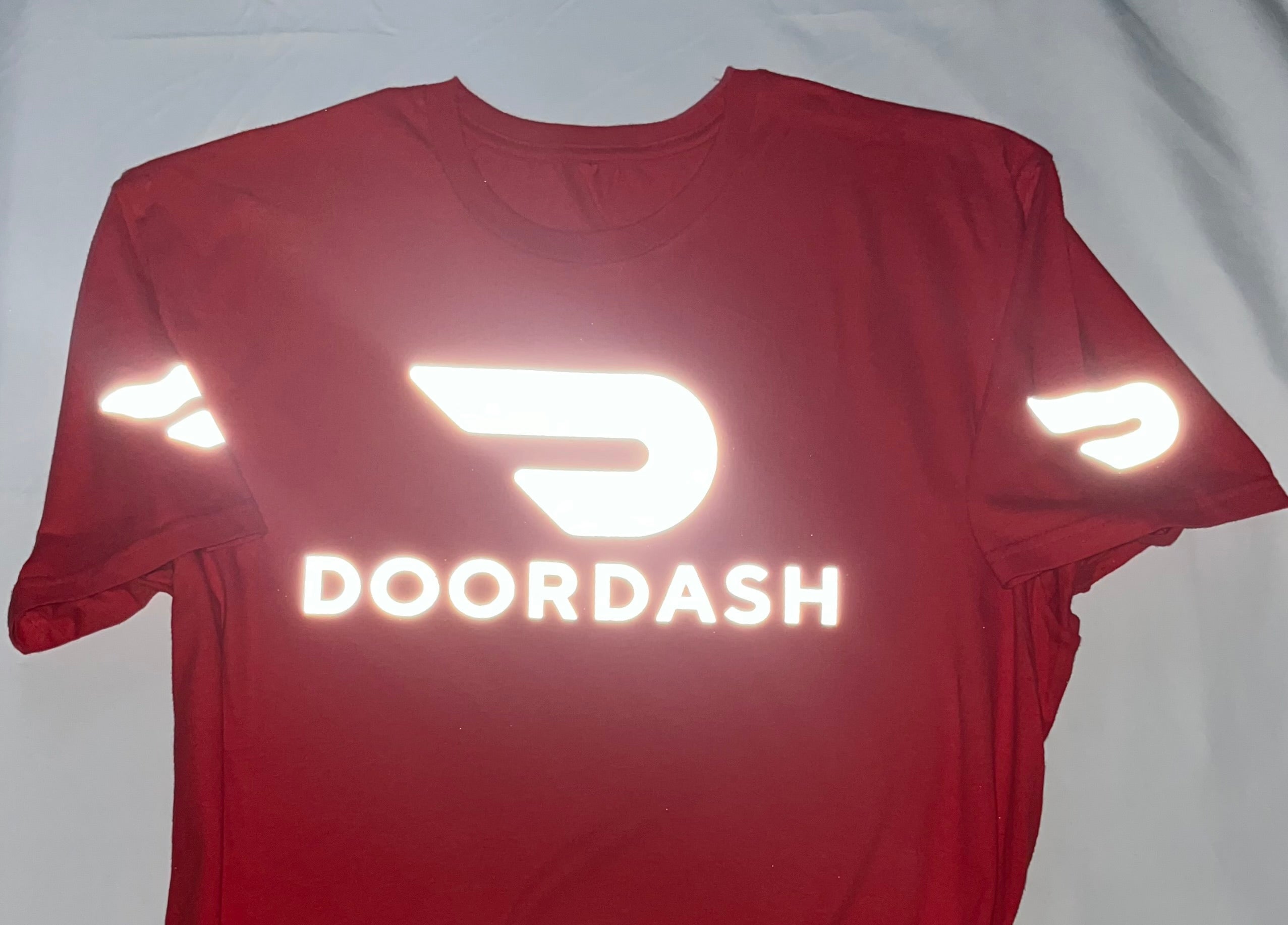 Reflective Red t-shirt with DoorDash logo and reflective elements on a white background